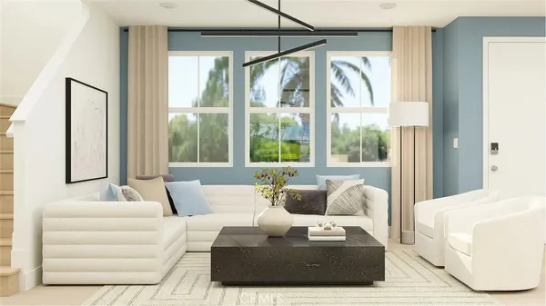 a living room with furniture and large windows