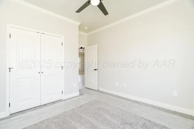 an empty room with chandelier fan