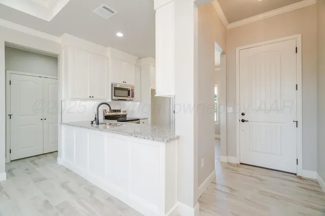 a kitchen with a sink and a refrigerator