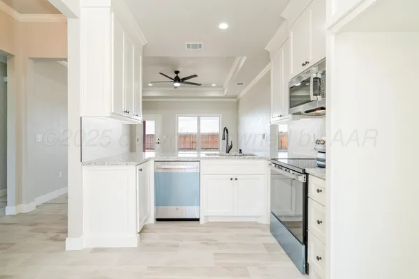 a kitchen with stainless steel appliances granite countertop a stove a sink and a refrigerator