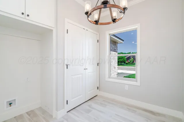 a view of a hallway with wooden floor and entryway