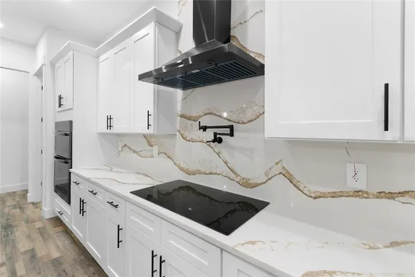 a kitchen with a stove cabinets and a refrigerator