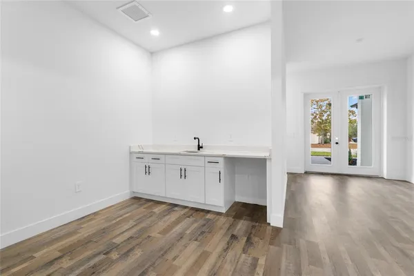 a view of a kitchen with wooden floor
