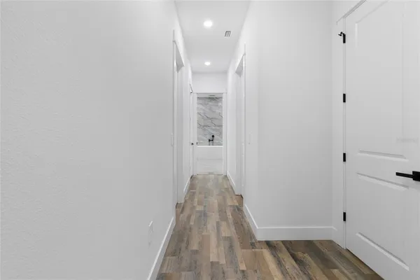 a view of a room with wooden floor and closet