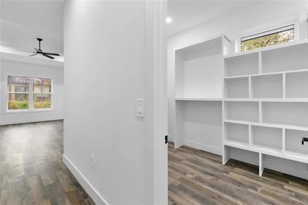a view of walk in closet with empty racks