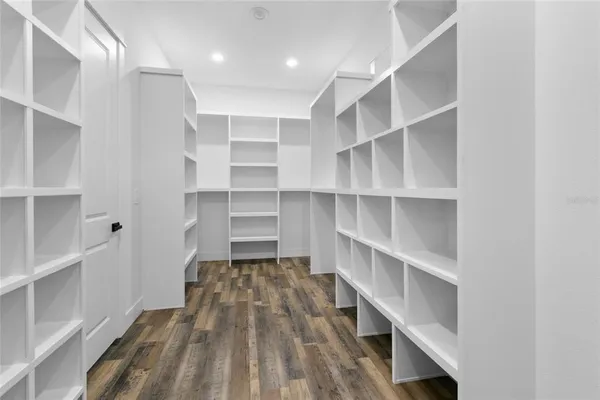 a view of walk in closet with empty racks