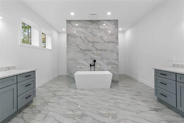 a spacious bathroom with a double vanity sink and a mirror