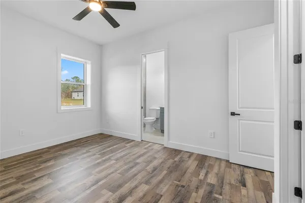 a bathroom with a toilet a sink a mirror and vanity