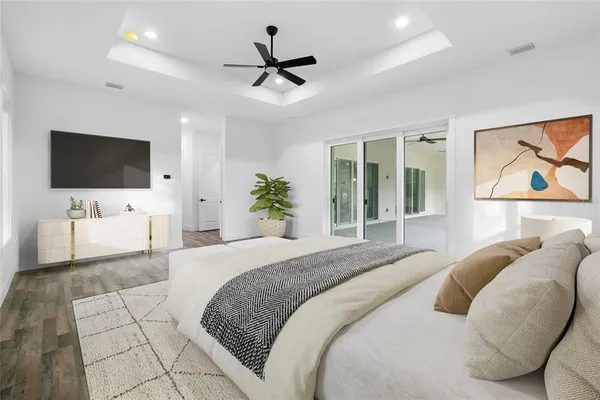 a bedroom with a large bed and a flat screen tv