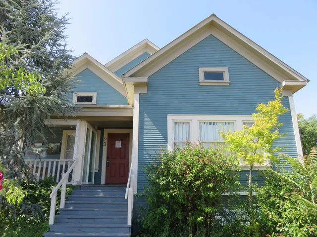 a dining room with furniture a rug and wooden floor