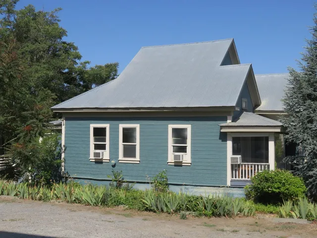 a backyard of a house with plants and trees
