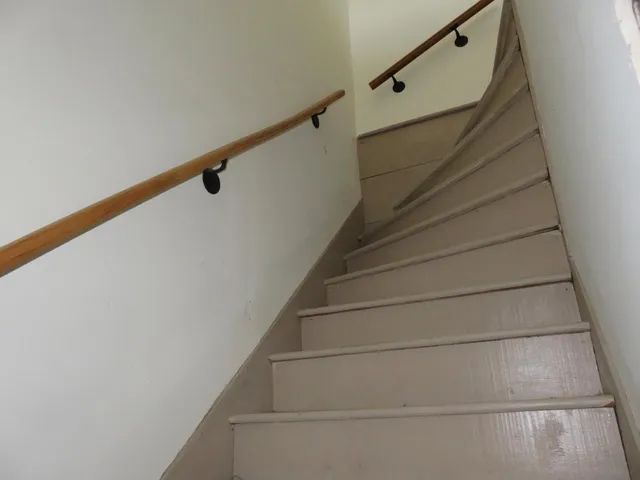 a bedroom with a couch and a window