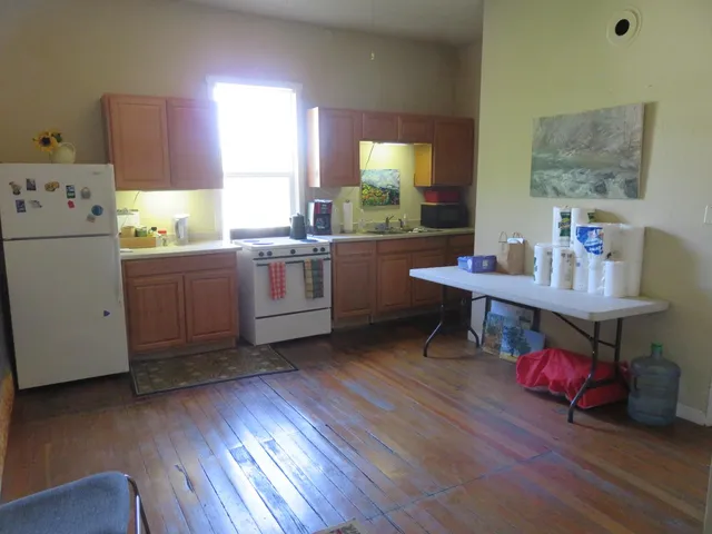 a kitchen with a table chairs and a window