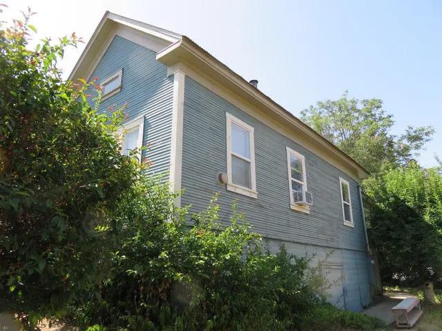a front view of house with yard and trees around