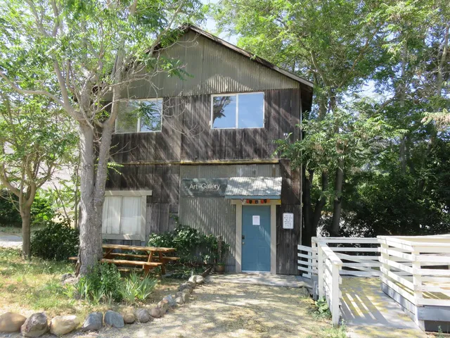 a wooden bench sitting in the middle of a yard