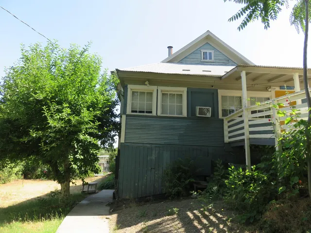 a view of a city from a dining room with large windows