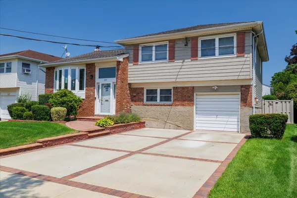 a front view of a house with a yard and outdoor seating