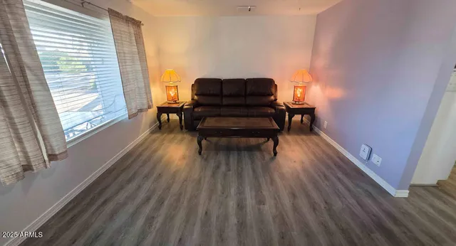 a living room with furniture and wooden floor