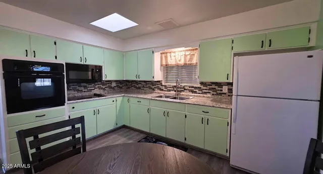 a kitchen with stainless steel appliances granite countertop a refrigerator and a microwave