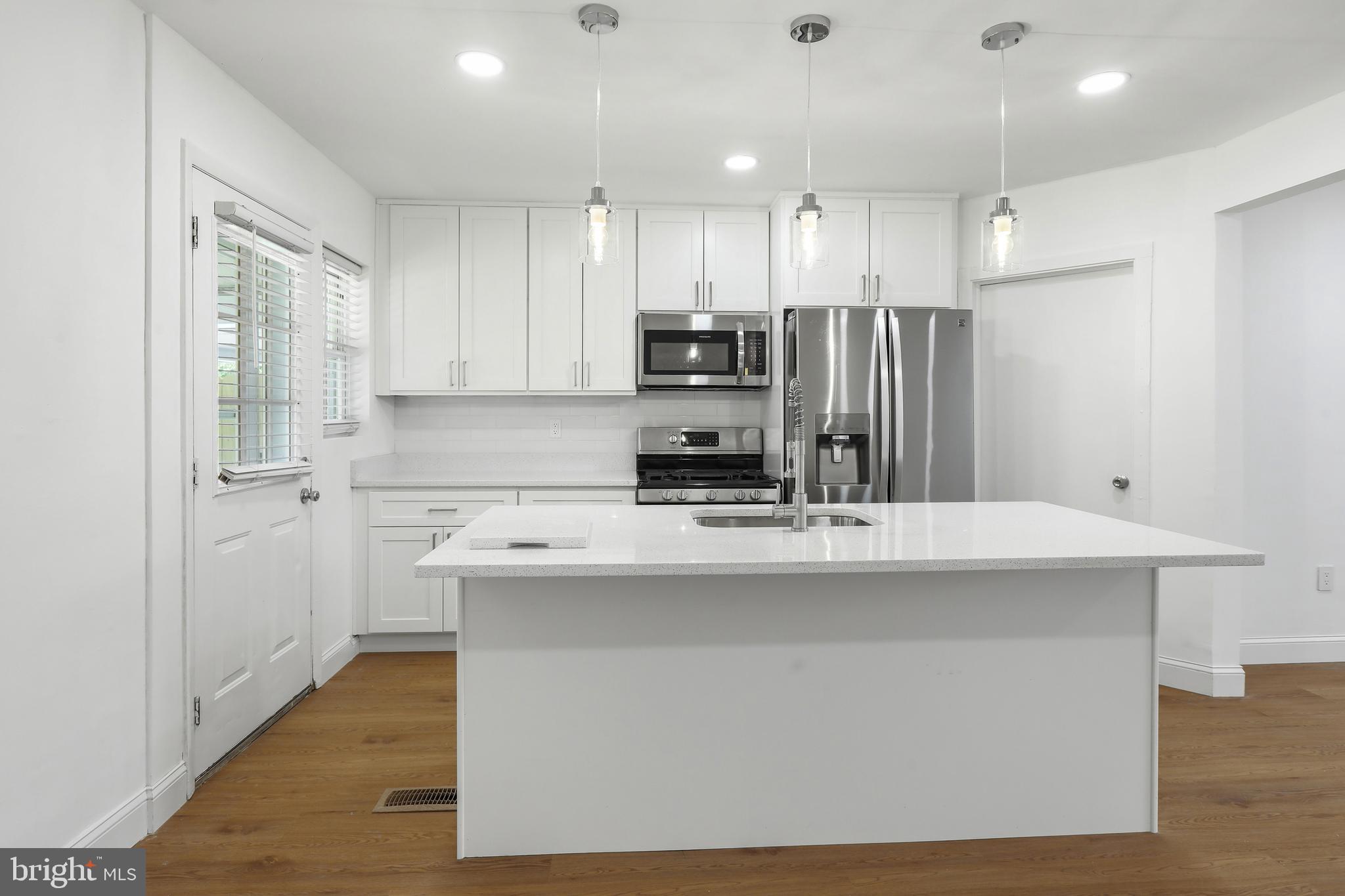 1714 Pin Oak Road Parkville, MD 21234 - Photo 12 of 41 Kitchen w/ white shaker cabinets & door to patio