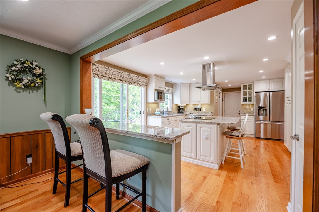 77 Misty Pine Road Perinton, NY 14450 - Photo 16 of 47 THE BREAKFAST BAR CAN HAVE SEATING AT BOTH FAMILY
