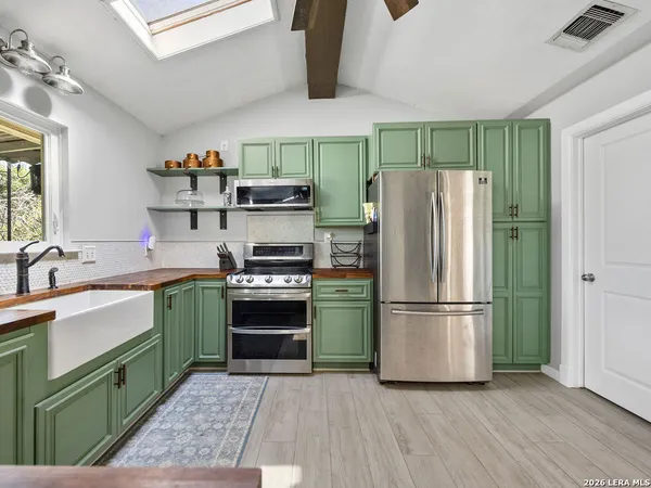 a kitchen with a refrigerator and a sink