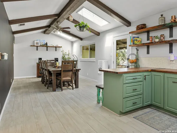 a dining room with furniture and a large window