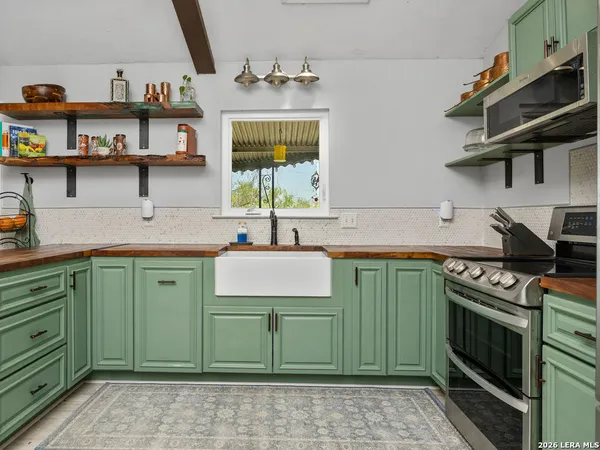 a kitchen with cabinets and a stove