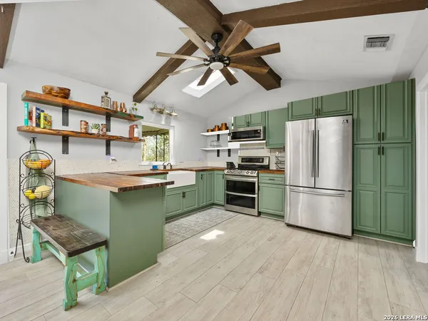 a kitchen with a refrigerator and a sink