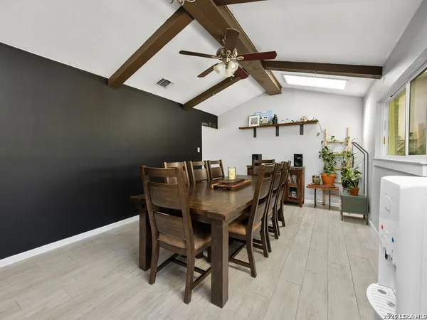 a view of a dining room with furniture and wooden floor