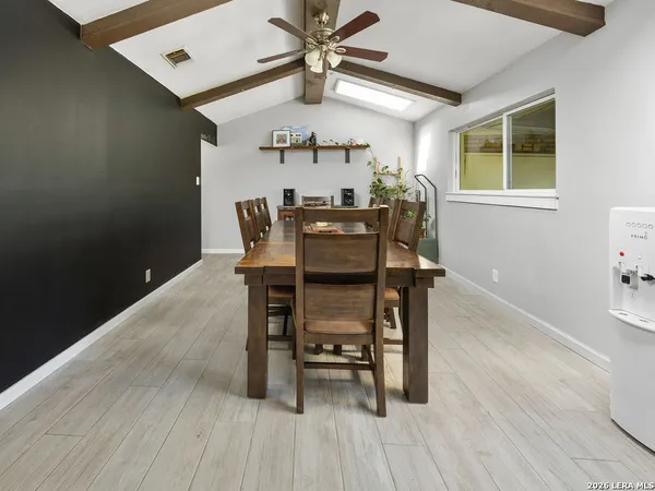 a view of a dining room with furniture and wooden floor
