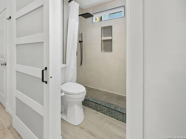 a bathroom with a toilet sink and a shower