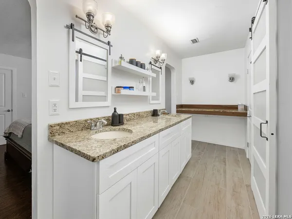 a kitchen with granite countertop a sink and cabinets