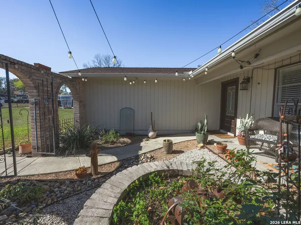 a backyard of a house with yard and outdoor seating