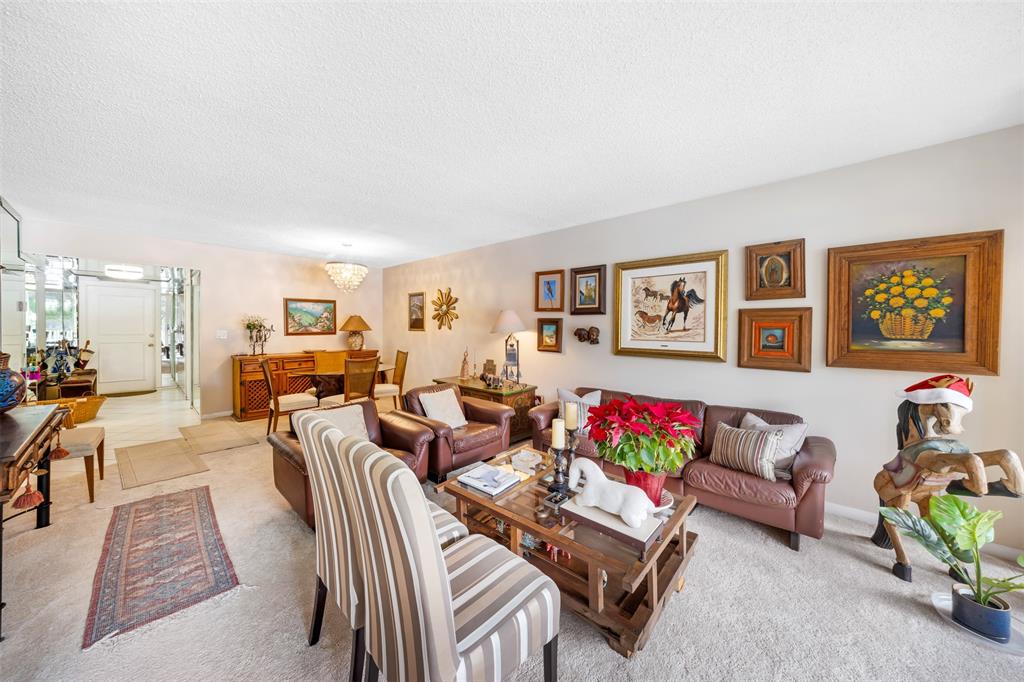 3150 North Course Lane, Unit 203 Pompano Beach, FL 33069 - Photo 11 of 26 a living room with furniture and a living room