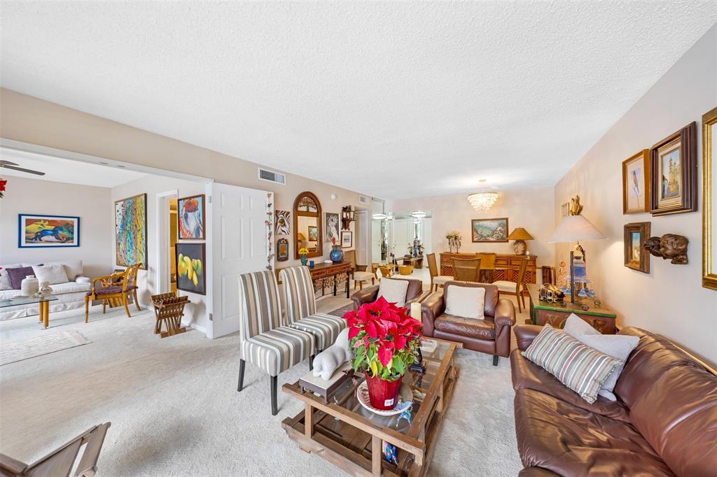 3150 North Course Lane, Unit 203 Pompano Beach, FL 33069 - Photo 12 of 26 a living room with furniture and toys