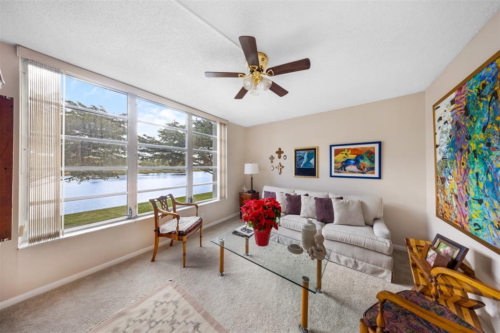 3150 North Course Lane, Unit 203 Pompano Beach, FL 33069 - Photo 13 of 26 a living room with furniture and a large window