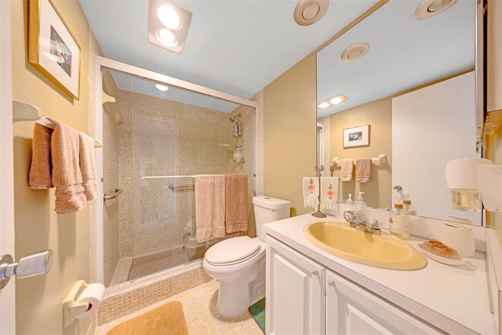 3150 North Course Lane, Unit 203 Pompano Beach, FL 33069 - Photo 16 of 26 a bathroom with a sink a toilet and shower