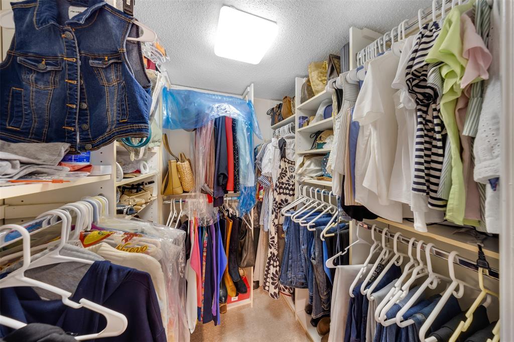 3150 North Course Lane, Unit 203 Pompano Beach, FL 33069 - Photo 22 of 26 a view of walk in closet with clothes and shoes