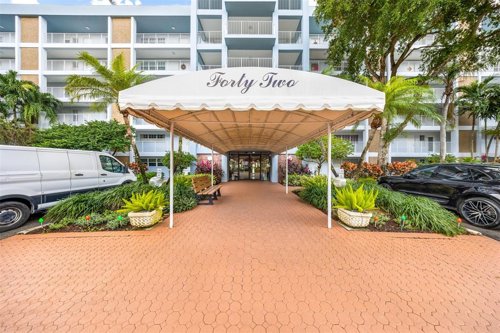 3150 North Course Lane, Unit 203 Pompano Beach, FL 33069 - Photo 25 of 26 a view of a table and chairs in front of a building
