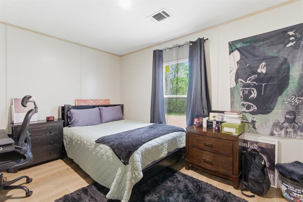 8792 Highway 67 Saltillo, TX 75478 - Photo 29 of 40 a bedroom with a bed and a dresser