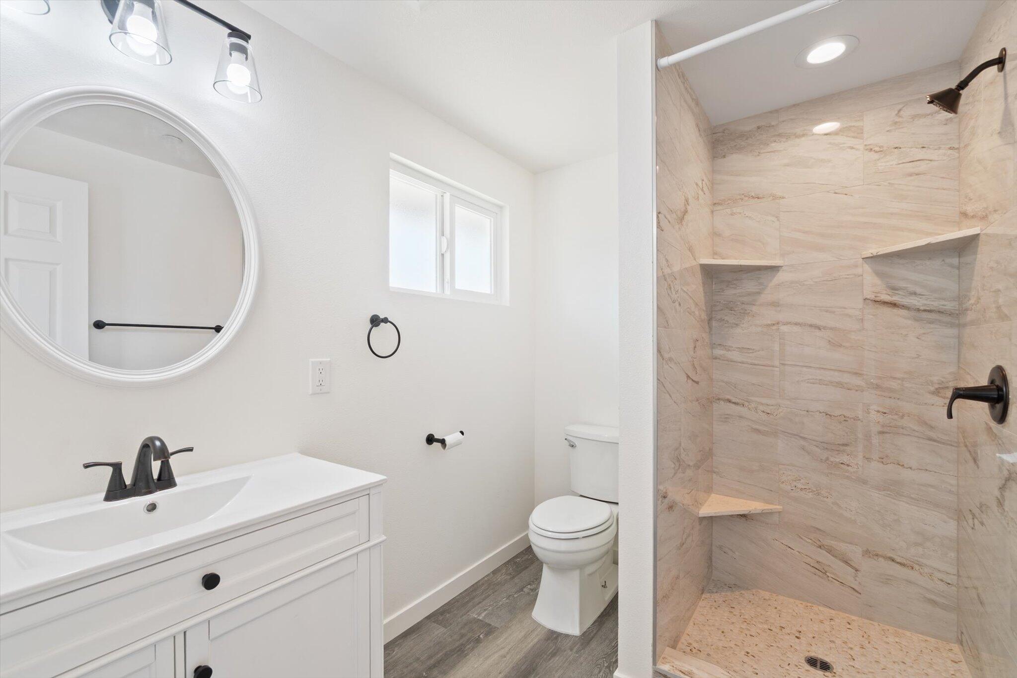 3276 School Street Redding, CA 96002 - Photo 12 of 36 a bathroom with a sink a toilet and shower