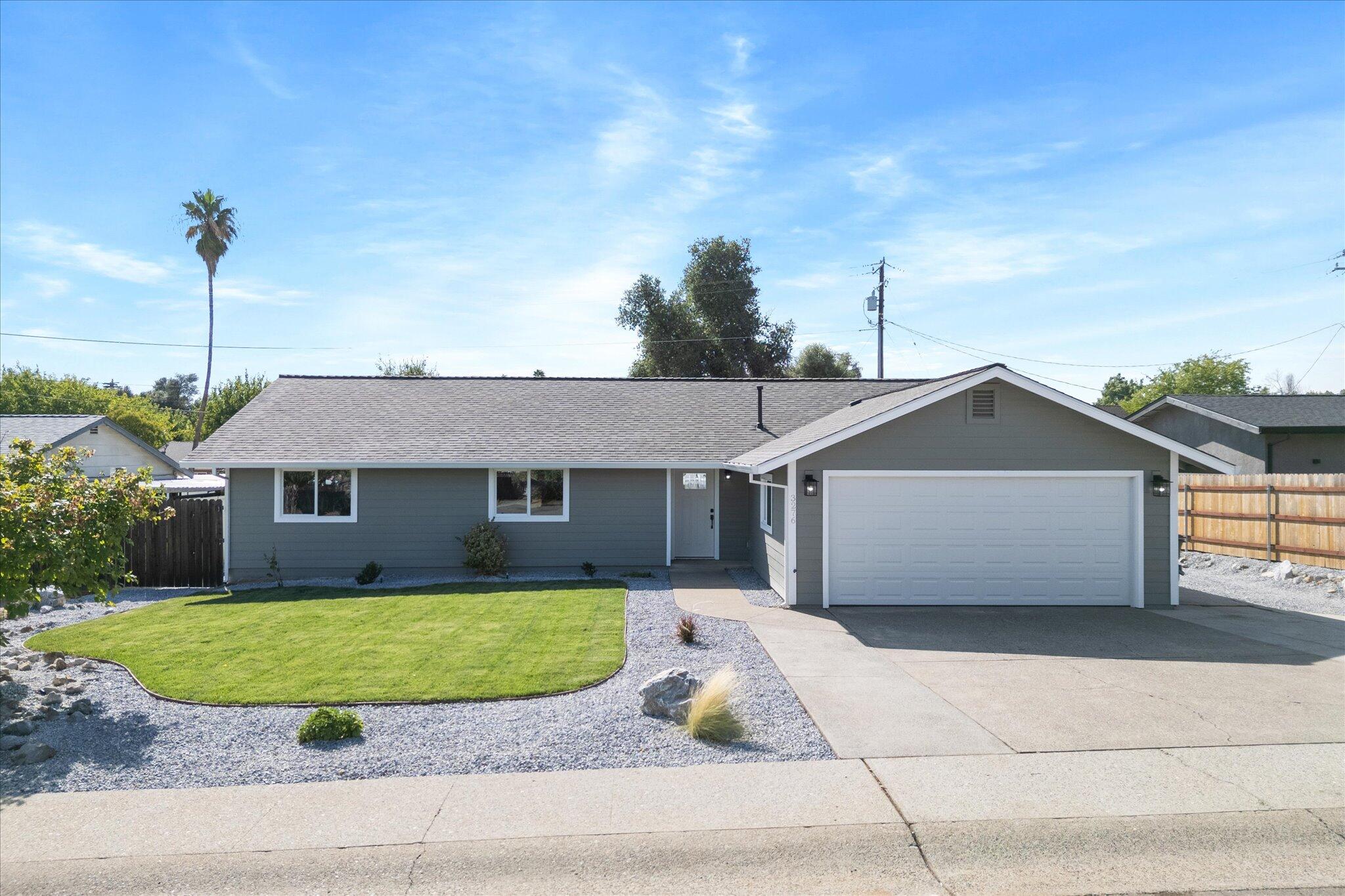 3276 School Street Redding, CA 96002 - Photo 29 of 36 a front view of a house with a garden and garage