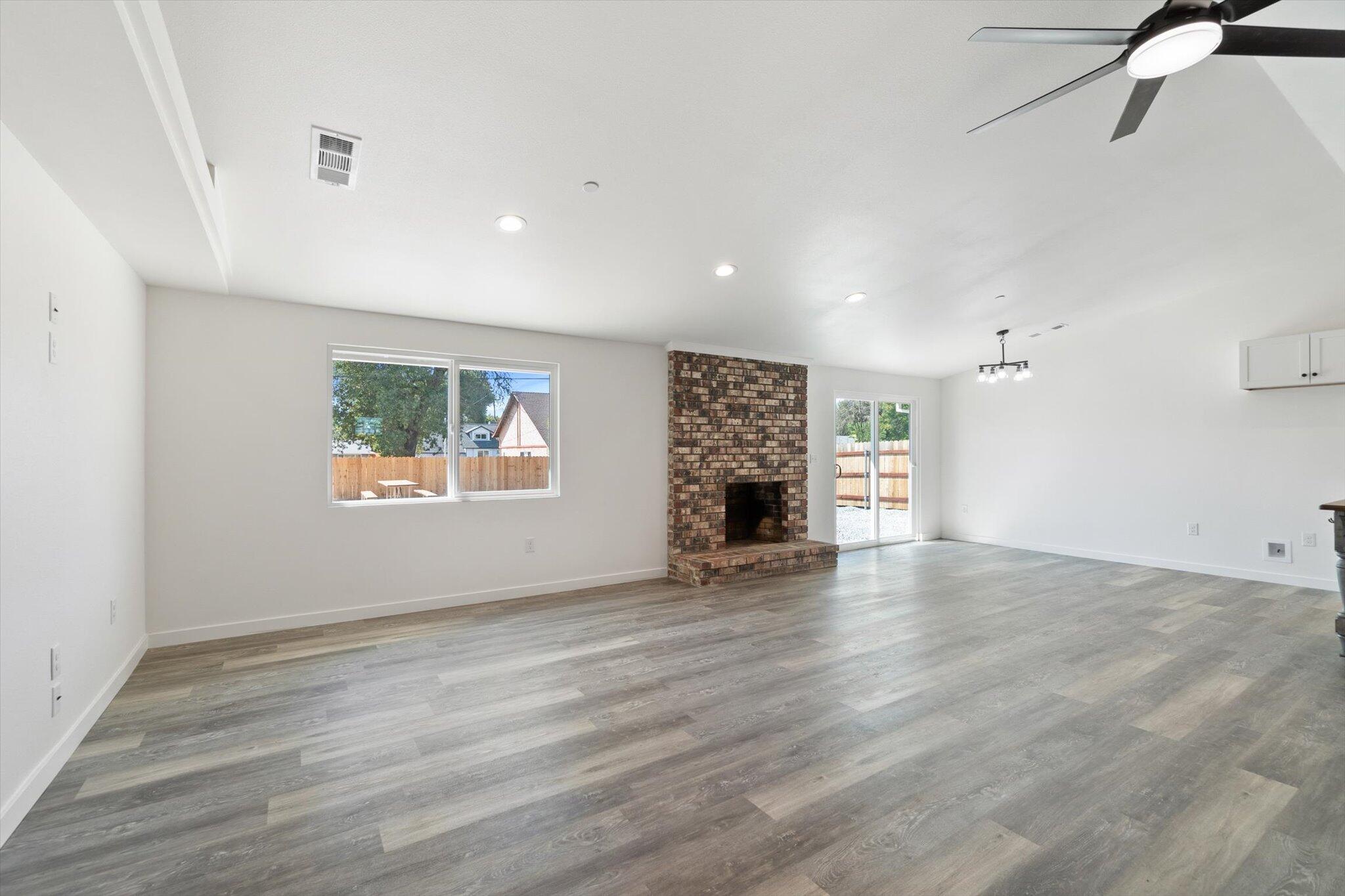 3276 School Street Redding, CA 96002 - Photo 7 of 36 wooden floor in an empty room with a window