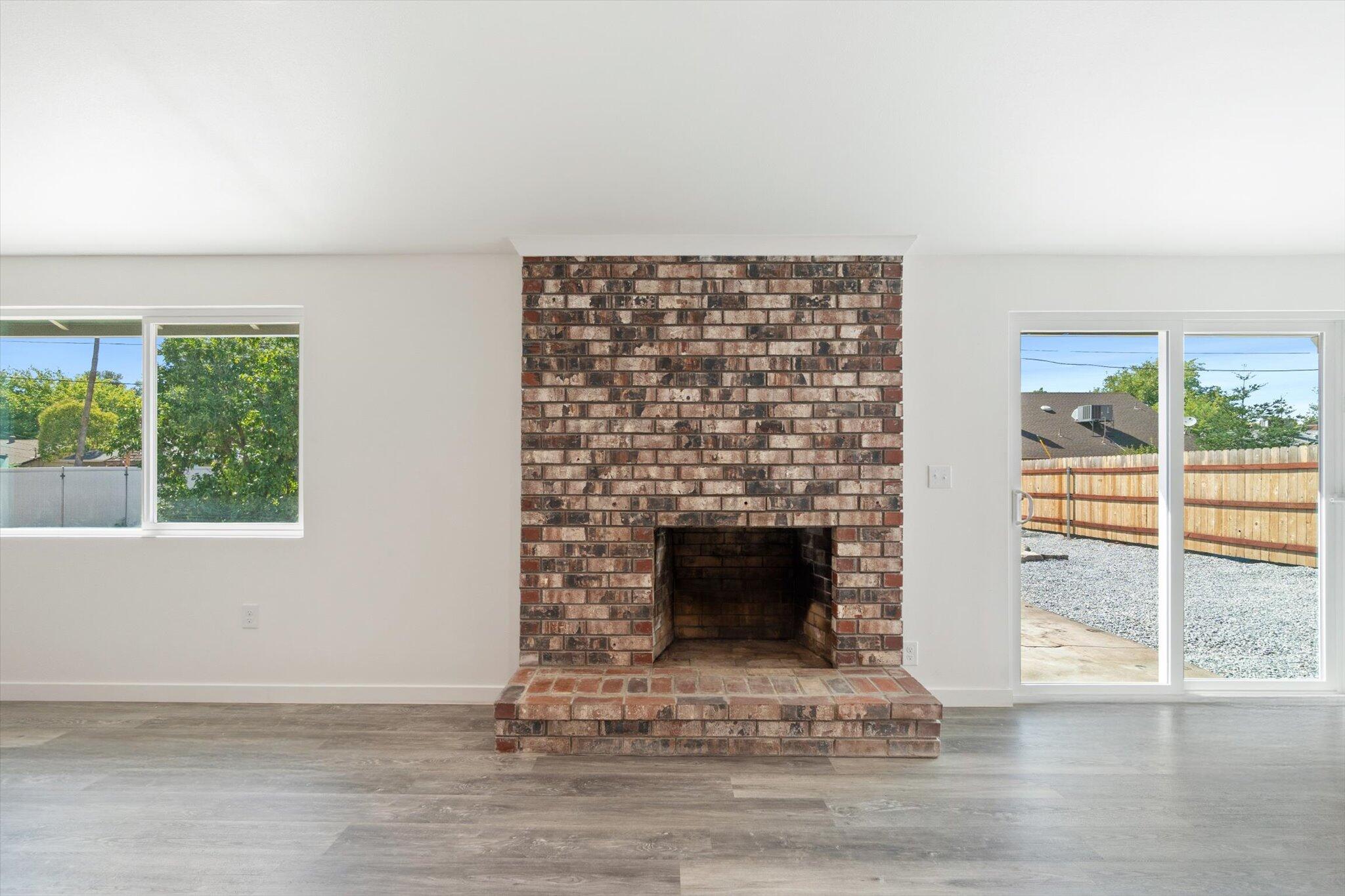 3276 School Street Redding, CA 96002 - Photo 8 of 36 a living room with a fireplace and a floor to ceiling window