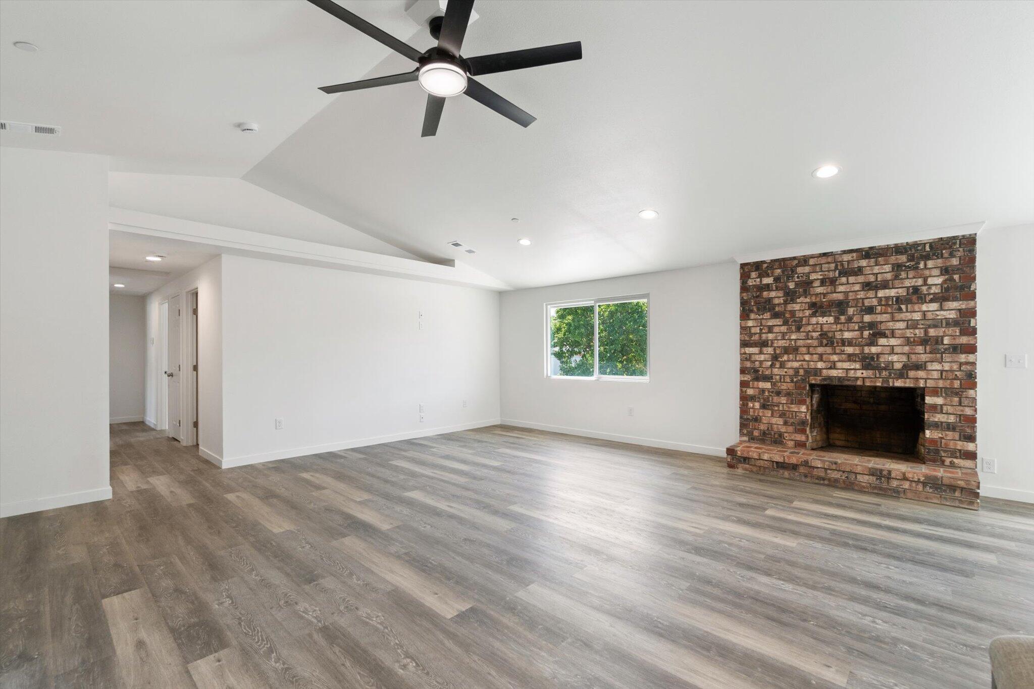 3276 School Street Redding, CA 96002 - Photo 9 of 36 an empty room with windows and fireplace