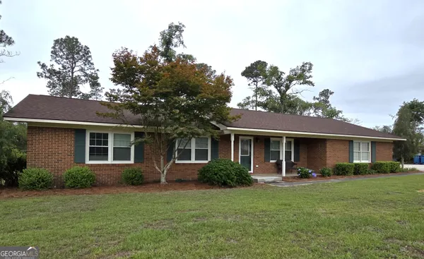 a front view of house with yard and green space