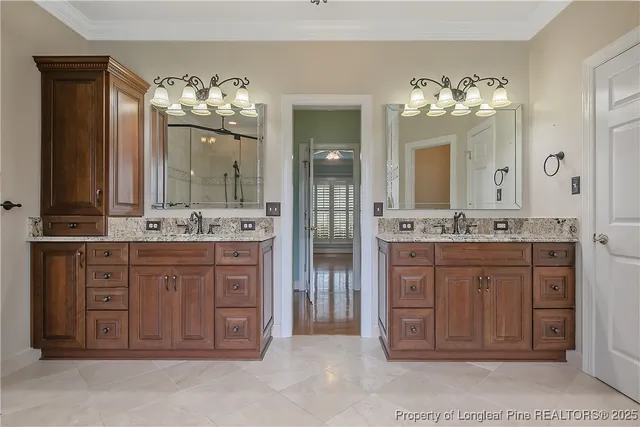 a bathroom with a granite countertop sink and a large mirror
