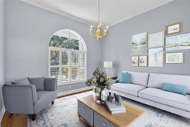 a living room with furniture and a chandelier