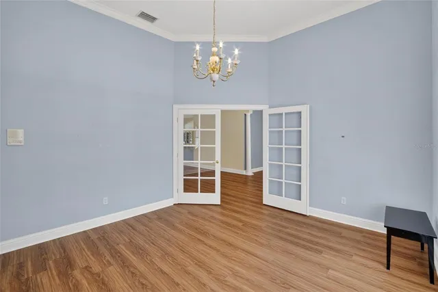 a large kitchen with stainless steel appliances lots of counter space and wooden floor